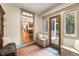 Inviting entryway with brick flooring, built-in bench seating, and a view into the home's kitchen at 390 Hembree Rd, Roswell, GA 30075