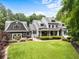 Beautiful two story home with meticulously maintained landscaping and large front lawn at 390 Hembree Rd, Roswell, GA 30075