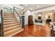 Spacious foyer with hardwood floors, staircase, and view of the living room, creating a welcoming entrance at 390 Hembree Rd, Roswell, GA 30075