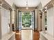 Inviting foyer with hardwood floors, traditional columns, and an open doorway leading to the outdoors at 390 Hembree Rd, Roswell, GA 30075