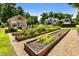 Backyard garden and greenhouse surrounded by landscaping at 390 Hembree Rd, Roswell, GA 30075