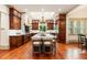 Spacious kitchen featuring hardwood floors, an island with seating, and custom cabinetry at 390 Hembree Rd, Roswell, GA 30075