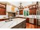 Gourmet kitchen with a large island, stainless steel appliances, and custom cabinetry at 390 Hembree Rd, Roswell, GA 30075