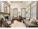 Comfortable living room with a fireplace, built-in shelves, and a plush sofa with decorative pillows at 390 Hembree Rd, Roswell, GA 30075