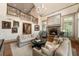 Spacious living room with a stone fireplace, tall ceilings, and abundant natural light at 390 Hembree Rd, Roswell, GA 30075