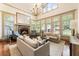 Bright living room with fireplace, hardwood floors, and large windows offering plenty of natural light at 390 Hembree Rd, Roswell, GA 30075