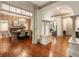 Spacious living room featuring hardwood floors, exposed brick wall, and elegant archways at 390 Hembree Rd, Roswell, GA 30075