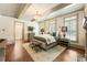 Serene main bedroom with a chandelier, hardwood floors, and ensuite bathroom entrance at 390 Hembree Rd, Roswell, GA 30075