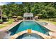 Backyard pool featuring a spa, lounge chairs, and an outdoor bar area at 390 Hembree Rd, Roswell, GA 30075