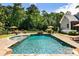 Backyard pool featuring a spa, lounge chairs, and a fire pit area at 390 Hembree Rd, Roswell, GA 30075