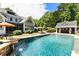 Backyard pool featuring a waterfall feature, lounge chairs, and an outdoor bar area at 390 Hembree Rd, Roswell, GA 30075