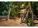 Unique treehouse in wooded area featuring a rustic design, wooden stairs, and a charming rooster emblem at 390 Hembree Rd, Roswell, GA 30075
