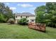 View of the backyard showing a wooden deck and a well-maintained lawn at 125 Winter Valley Ct, Fayetteville, GA 30215