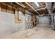 Unfinished basement with concrete floor and exposed utilities, offering ample storage space at 125 Winter Valley Ct, Fayetteville, GA 30215