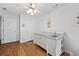 Neutral Bedroom features a white crib, ceiling fan, and two doors for easy access at 125 Winter Valley Ct, Fayetteville, GA 30215