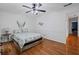 Bedroom features hardwood floors, a patterned comforter, and lots of natural light at 125 Winter Valley Ct, Fayetteville, GA 30215