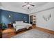 Bright main bedroom with trey ceiling, ceiling fan, hardwood floors, rug, and a blue accent wall at 125 Winter Valley Ct, Fayetteville, GA 30215