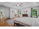 Bright main bedroom with trey ceiling, ceiling fan, hardwood floors, rug, and a blue accent wall at 125 Winter Valley Ct, Fayetteville, GA 30215