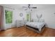 Bedroom features hardwood floors, a patterned comforter, and lots of natural light at 125 Winter Valley Ct, Fayetteville, GA 30215