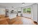 Bright eat-in kitchen featuring stainless appliances, white cabinets, an island, and hardwood floors at 125 Winter Valley Ct, Fayetteville, GA 30215