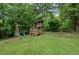 Backyard featuring a wooden playset with swings and a slide at 125 Winter Valley Ct, Fayetteville, GA 30215