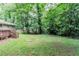 Expansive backyard with mature trees and potential fire pit area is perfect for outdoor entertaining at 1715 Lee St, Decatur, GA 30035