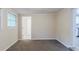 Bedroom featuring neutral walls, carpeted floors, and an open doorway leading to an adjoining room at 1715 Lee St, Decatur, GA 30035