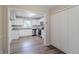 Charming kitchen with white cabinets, granite counters, stainless appliances, and wood-look floors at 1715 Lee St, Decatur, GA 30035