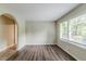 Bright living room with hardwood floors, freshly painted walls, and a large window at 1715 Lee St, Decatur, GA 30035