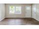 Neat living room featuring hardwood floors and lots of light from a large window and a glass door at 1715 Lee St, Decatur, GA 30035