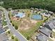 Delight in the aerial view showcasing the community pool, tennis courts, playground, and clubhouse at 178 Crestbrook Way, Dallas, GA 30157