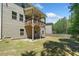 View of the home's backyard with the raised deck and stairs leading to the yard at 178 Crestbrook Way, Dallas, GA 30157