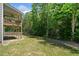 Spacious backyard with lawn, some shade and a view of the upper deck of the home at 178 Crestbrook Way, Dallas, GA 30157
