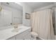 Bathroom with a vanity, toilet and shower with curtain, neutral color palette at 178 Crestbrook Way, Dallas, GA 30157