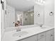 Bathroom featuring double sink vanity with white countertop and brushed metal faucets, and glass shower at 178 Crestbrook Way, Dallas, GA 30157