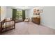 Spacious Bedroom with a crib, dresser, and a gallery wall of nature-themed art at 178 Crestbrook Way, Dallas, GA 30157