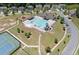 Aerial view of a beautiful community pool, playground, tennis court, and clubhouse in a lush neighborhood setting at 178 Crestbrook Way, Dallas, GA 30157