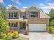 Beautiful two-story brick home featuring a welcoming front porch and a two-car garage at 178 Crestbrook Way, Dallas, GA 30157