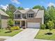 Attractive two-story brick home with a well-manicured lawn and an attached two-car garage at 178 Crestbrook Way, Dallas, GA 30157