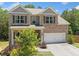 Charming two-story brick home with well-maintained landscaping, a porch and attached garage at 178 Crestbrook Way, Dallas, GA 30157