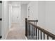 Hallway boasting modern design with carpeted floors, white walls and doors, and wood railing at 178 Crestbrook Way, Dallas, GA 30157