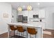 Modern kitchen featuring stainless steel appliances, granite countertops, and an island with seating at 178 Crestbrook Way, Dallas, GA 30157