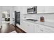Modern kitchen with stainless steel appliances, white cabinets, granite countertops, and gas range at 178 Crestbrook Way, Dallas, GA 30157