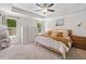 Serene primary bedroom with tray ceiling, soft carpet, dresser, mirror and windows with natural light at 178 Crestbrook Way, Dallas, GA 30157