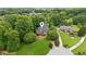 Aerial view of a charming brick home with well-manicured lawns, mature trees, and inviting curb appeal at 2610 Ginger Dr, Buford, GA 30519