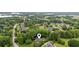 A high aerial shot shows the home's location in a neighborhood with mature trees and well-manicured lawns at 2610 Ginger Dr, Buford, GA 30519