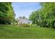 Expansive backyard, showcasing the lush green lawn, mature trees, and the home's exterior at 2610 Ginger Dr, Buford, GA 30519
