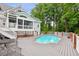 Backyard with in-ground pool, patio, stairs to porch, and surrounding trees at 2610 Ginger Dr, Buford, GA 30519