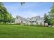 Expansive green lawn and a charming home exterior with a screened-in porch at 2610 Ginger Dr, Buford, GA 30519