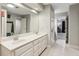 Bright bathroom featuring double vanity and a large mirror at 2610 Ginger Dr, Buford, GA 30519